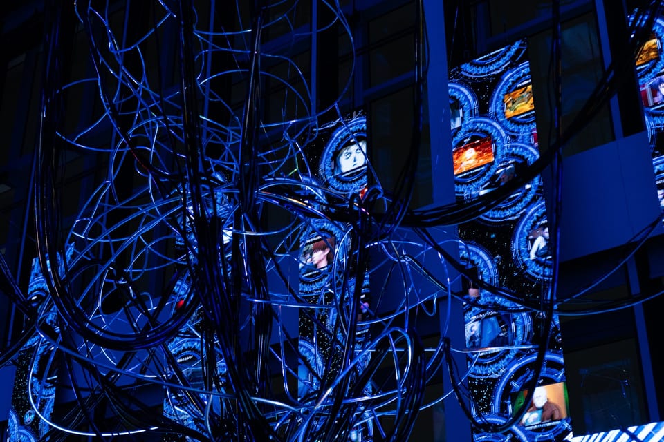 Ghost in the Shell Exhibition – Nerve Net installation view with multiple circular UI elements displayed across vertical LED panels
