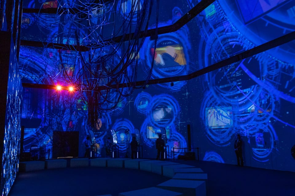 Ghost in the Shell Exhibition – Nerve Net installation view with circular UI elements projected across the entire curved wall